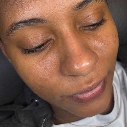 Close-up of groomed brows and radiant, hydrated-looking skin